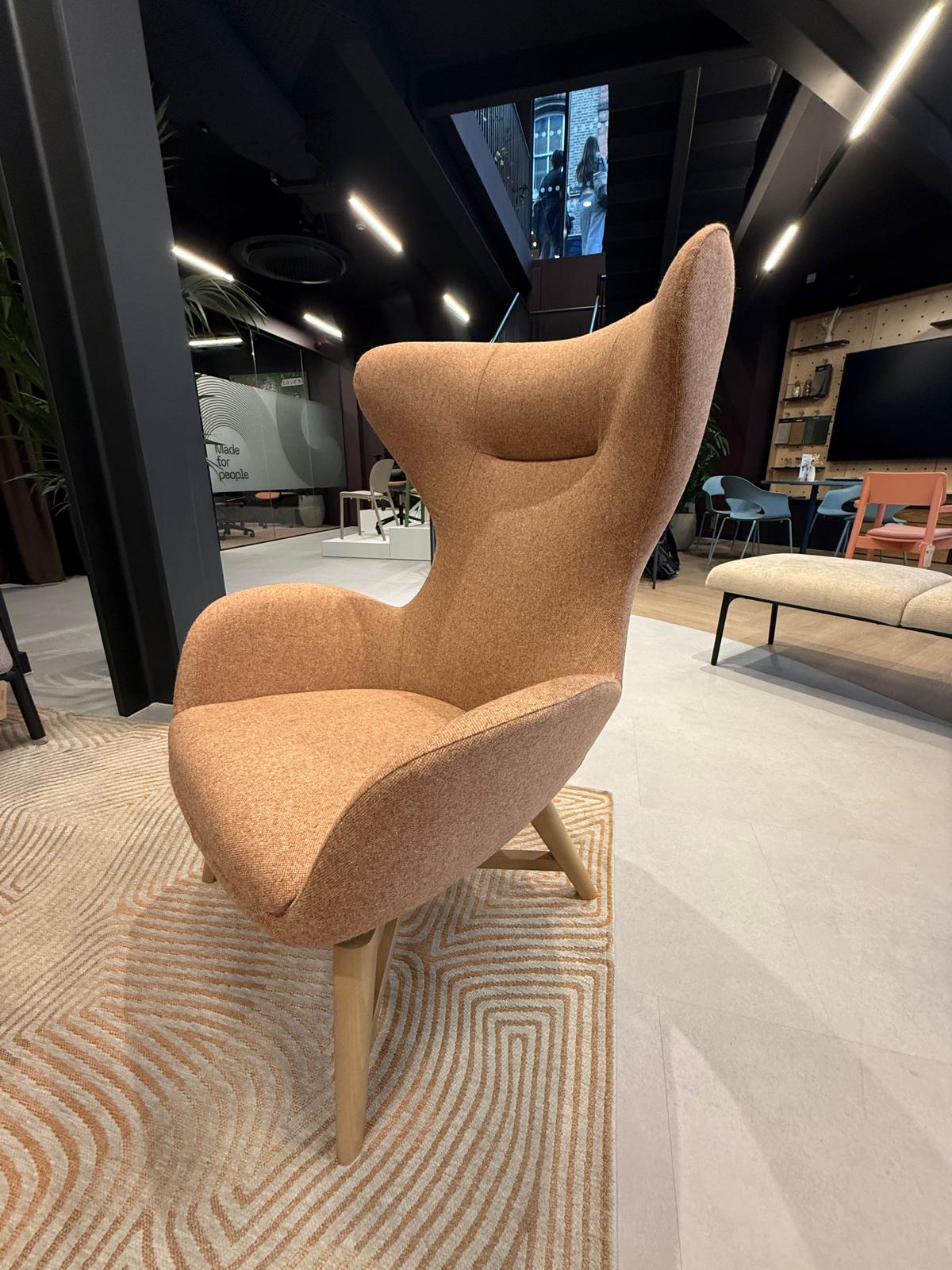Sculptural high-back lounge chair on timber legs