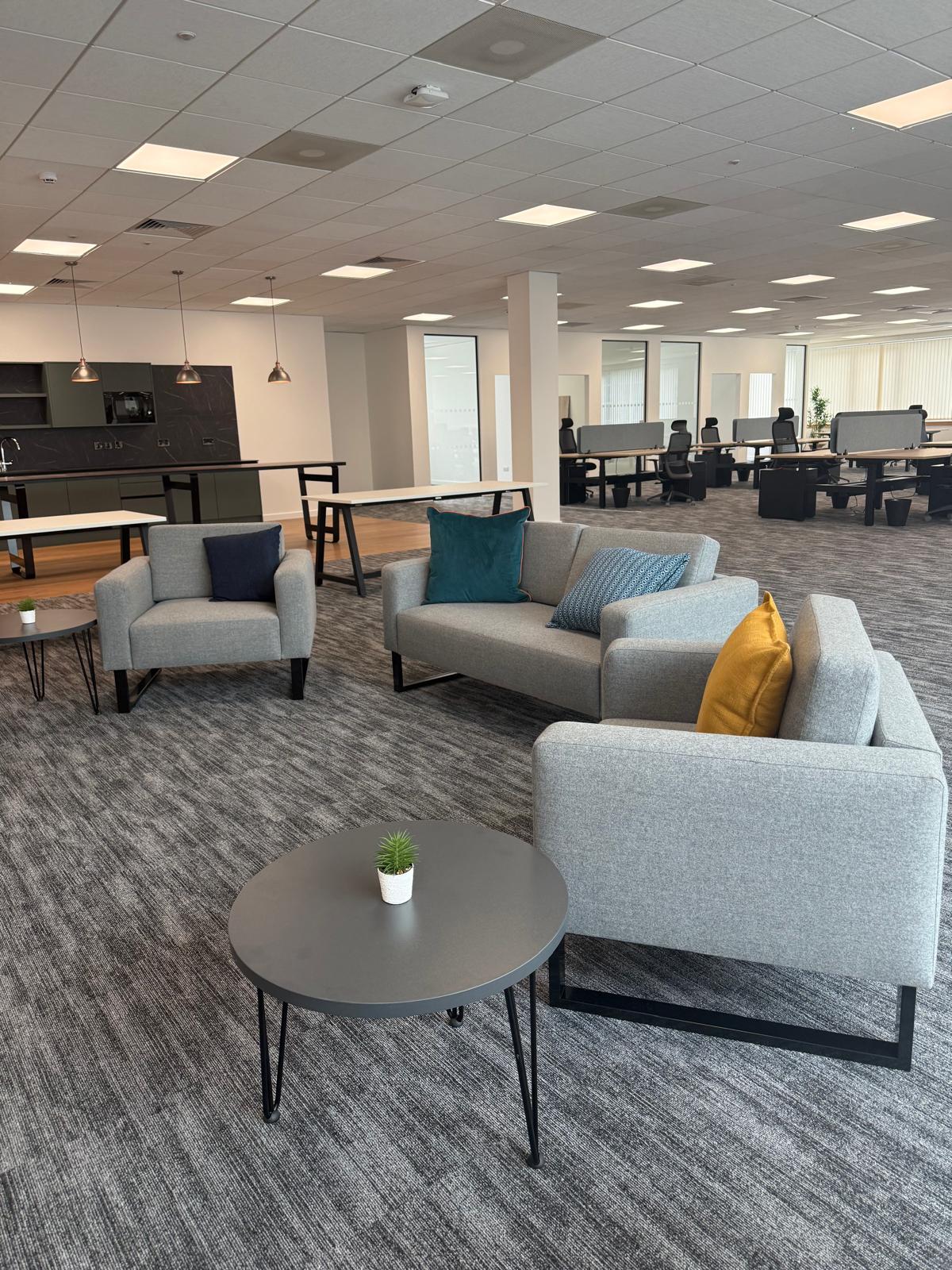 Completed breakout lounge with sofas, coffee tables and pendant lighting