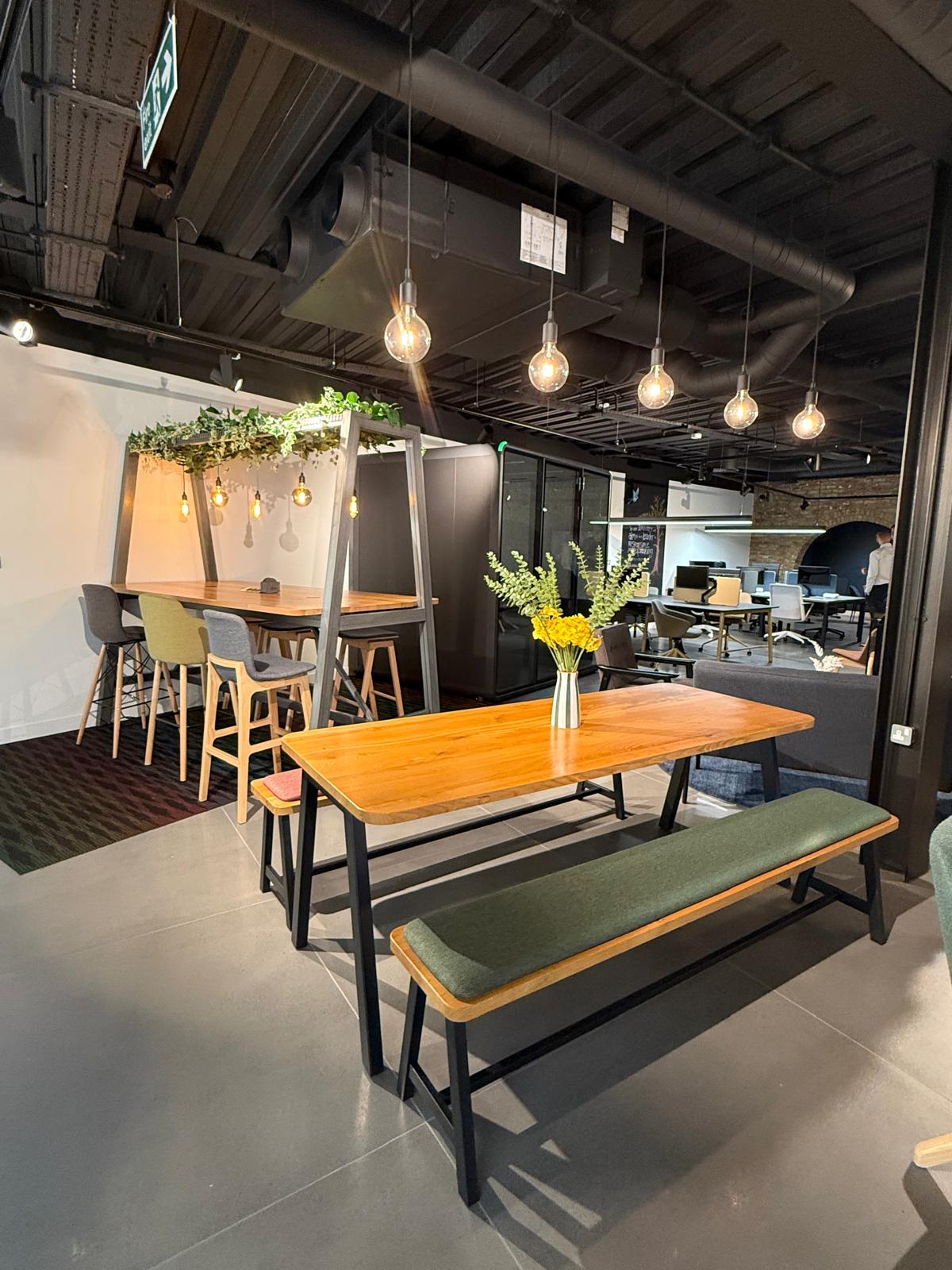 Dining-height table with bench seating in a breakout area