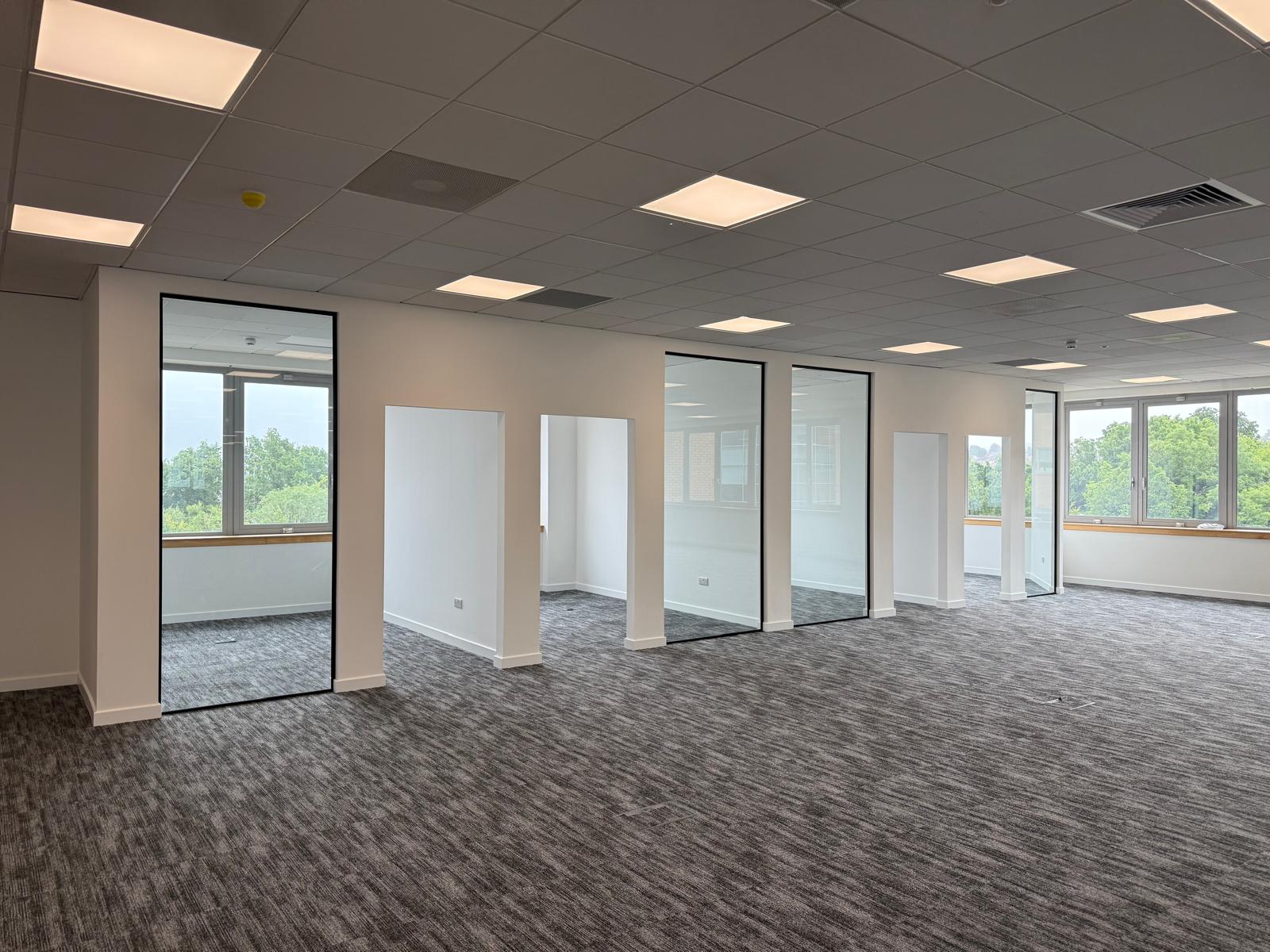 Glazed meeting rooms and open space ahead of the installation