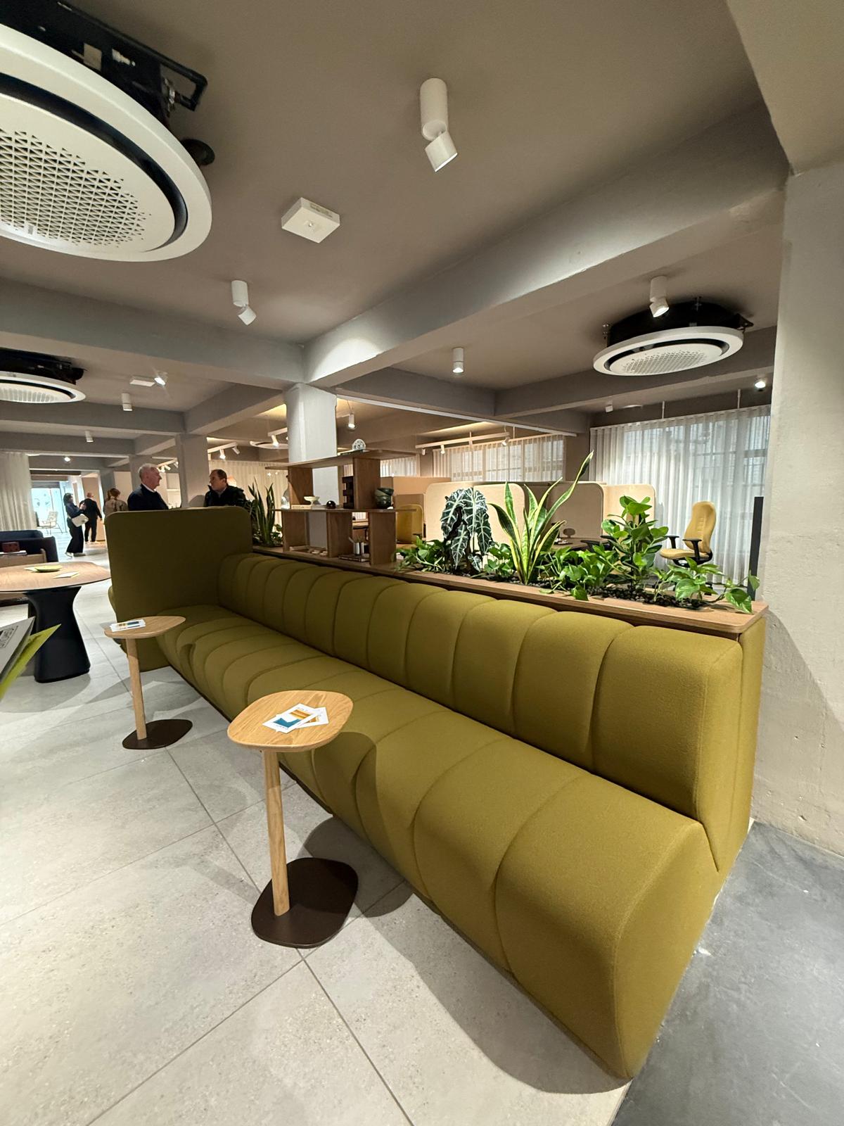 Mustard channel-stitched banquette seating with planter divide and oak side tables