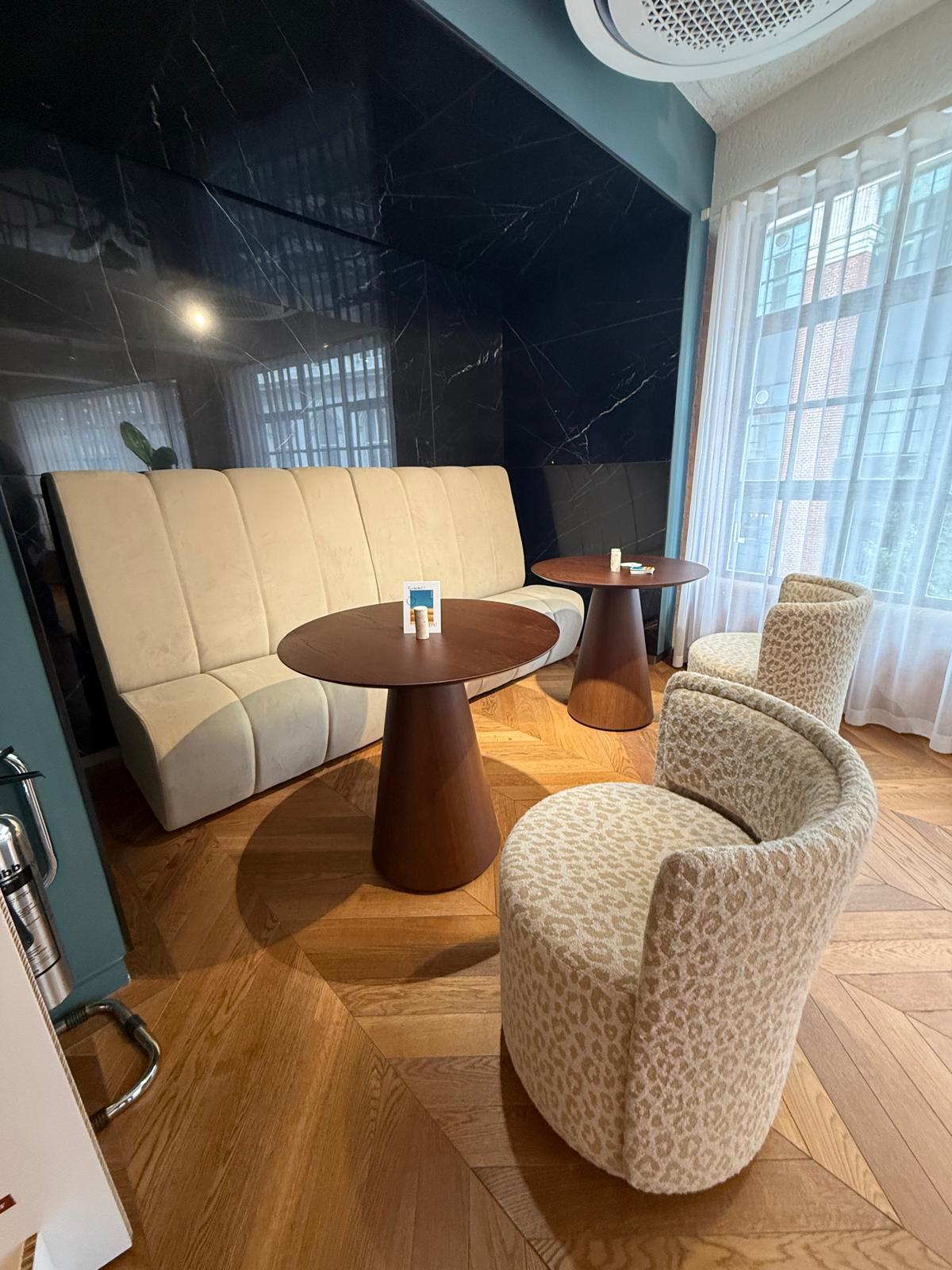 Fluted banquette seating with round timber café tables