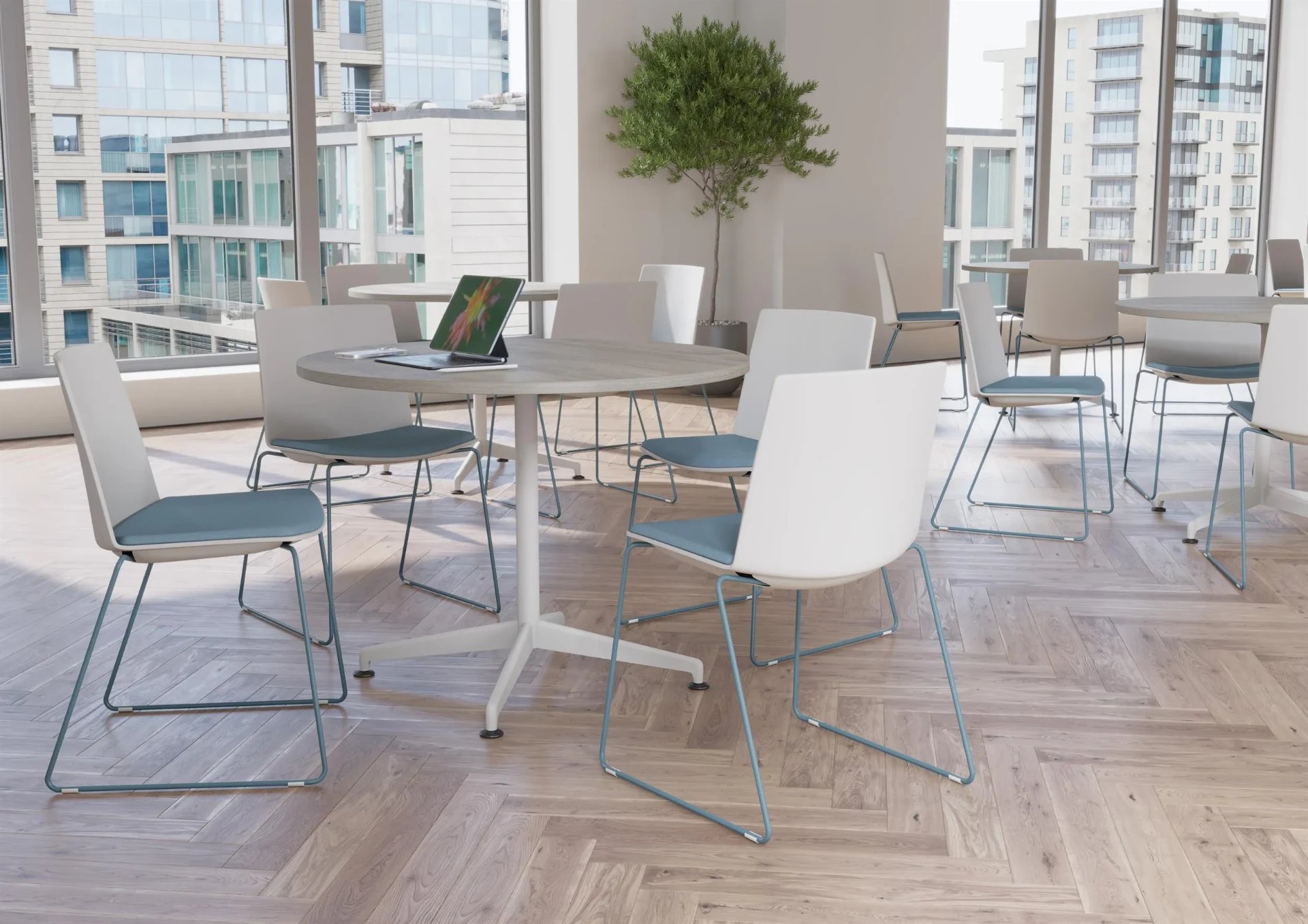 A café and breakout area with round tables and white chairs