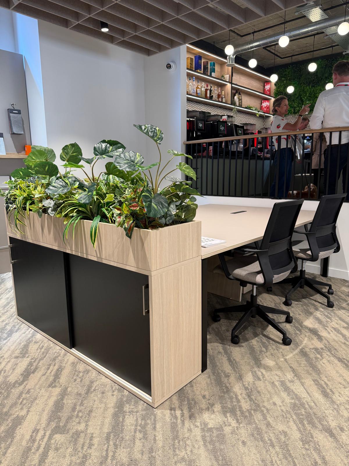 Bench desking with planter-topped storage and mesh task chairs