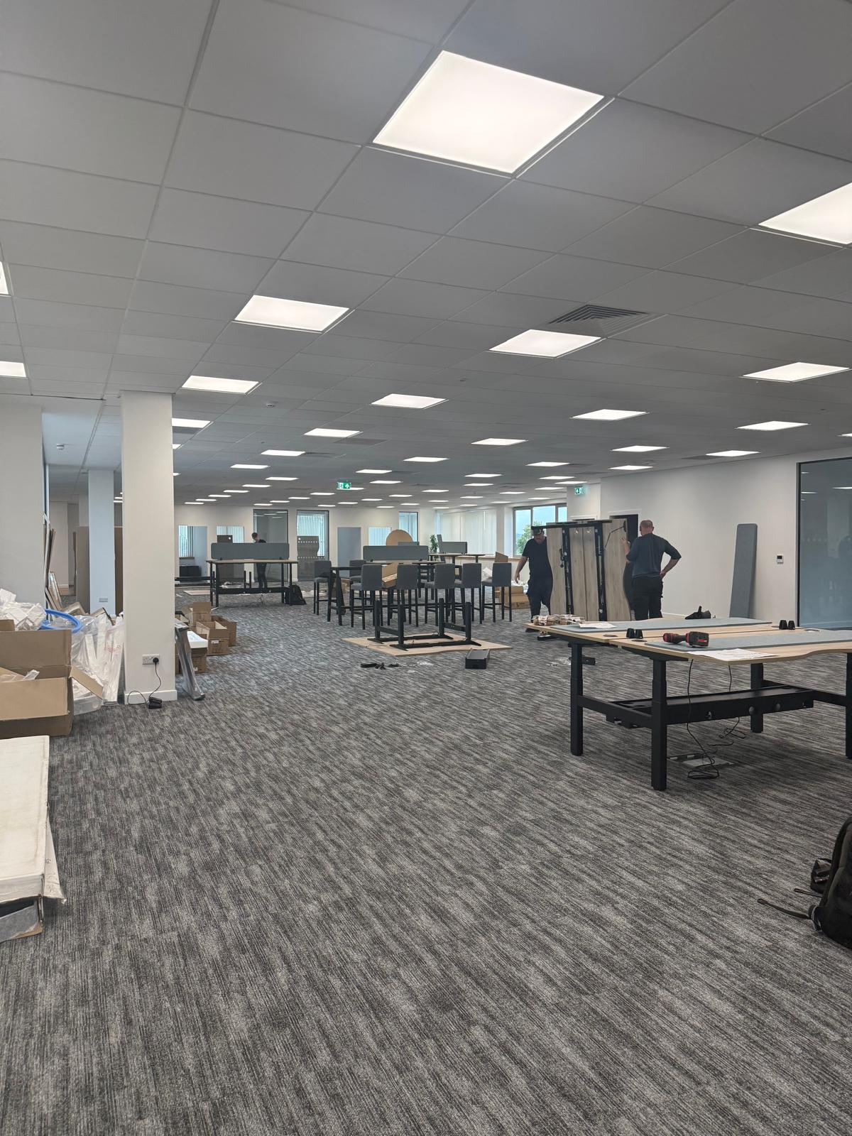 Installation underway with bench desking frames and screens being assembled