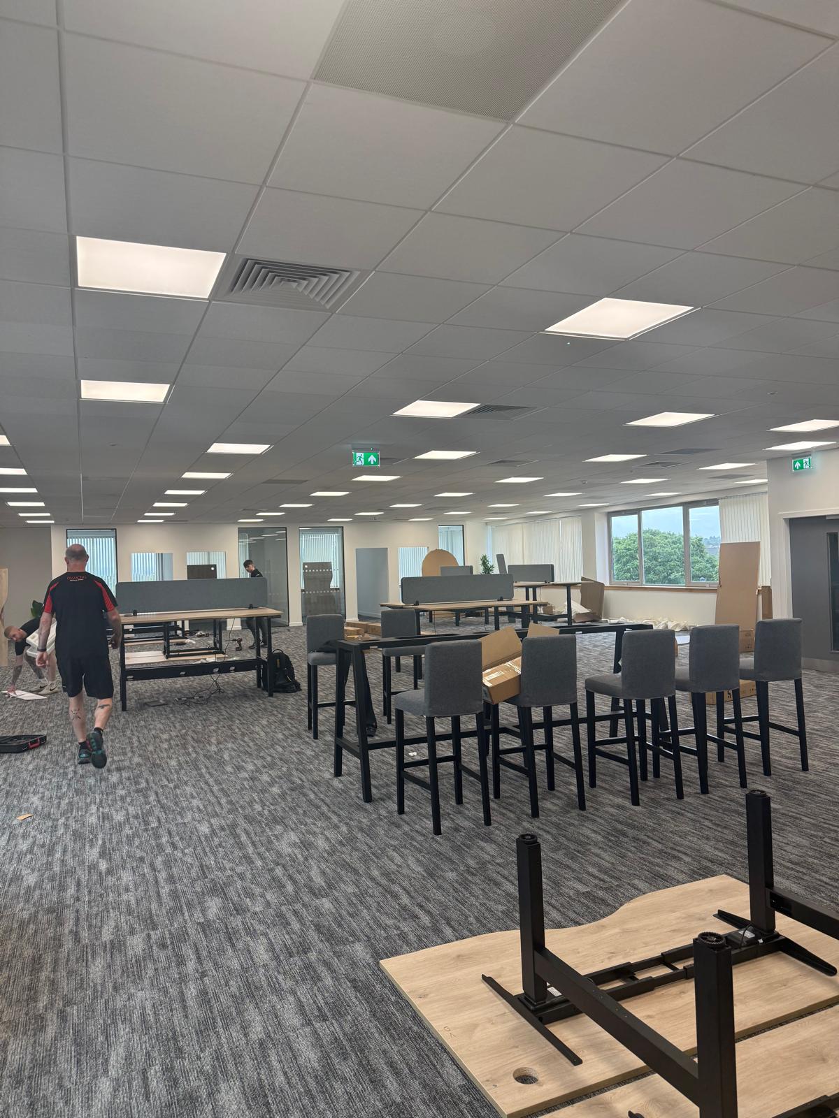 Bar-height tables and stools being positioned during the fit out
