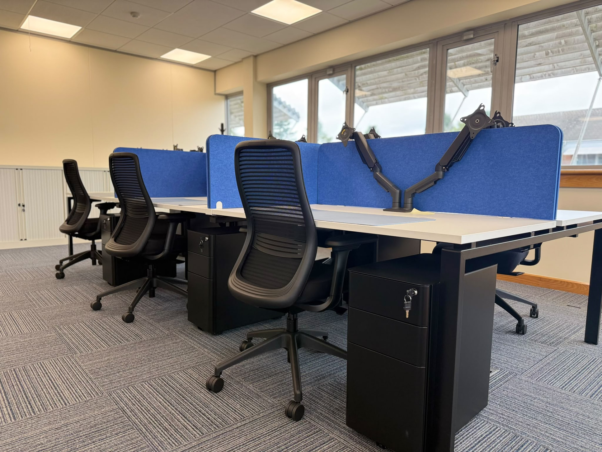 Finished workstations with lockable pedestals, monitor arms and acoustic screens