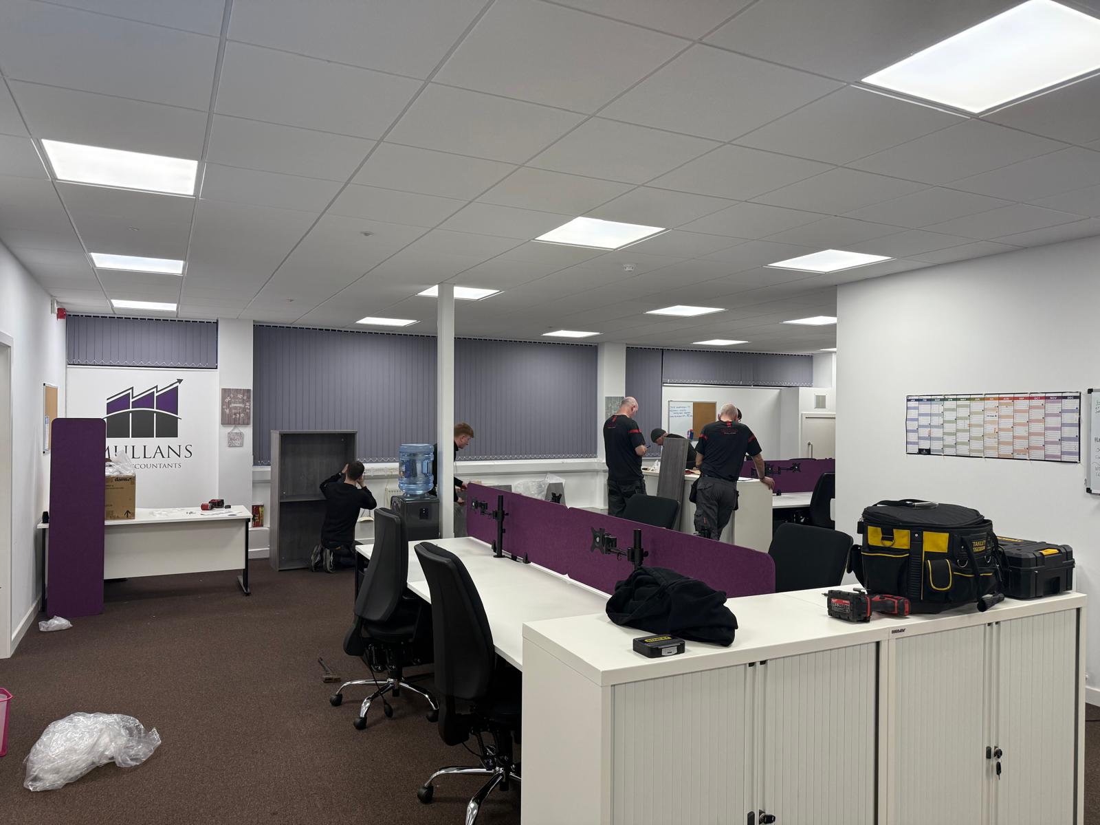 Installation team fitting storage and workstations at Mullans Law Accountants