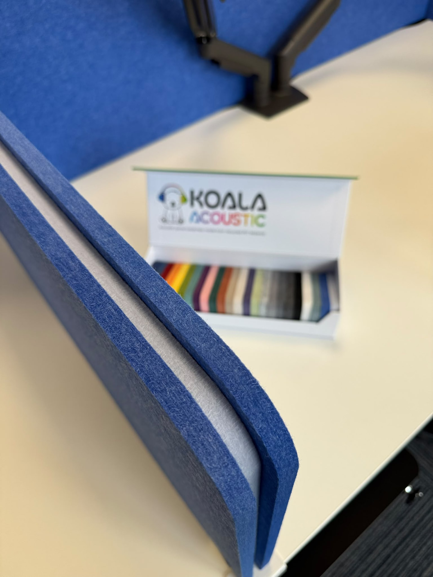 Close-up detail of the blue acoustic desk screens and colour swatches