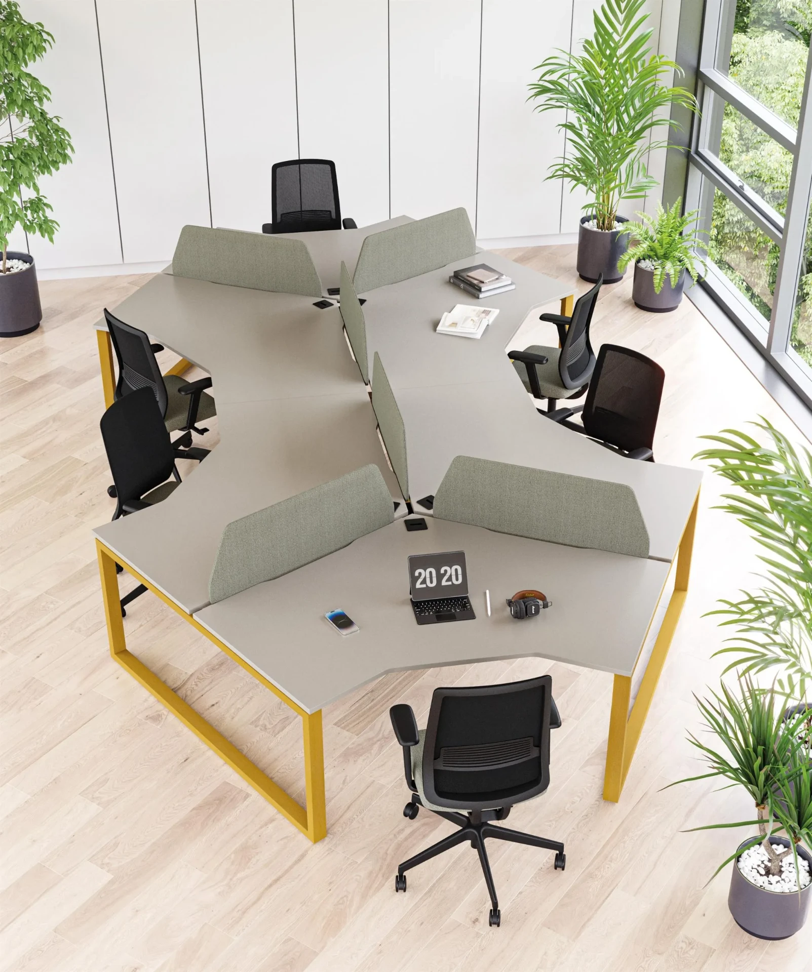 A cluster of light-grey workstation desks with soft screens, yellow frames and plants