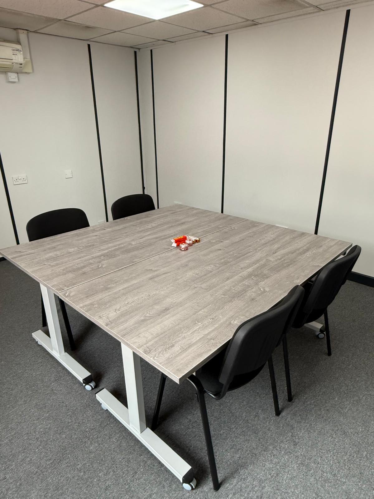 Close-up of the light grey woodgrain table tops in the workshop layout